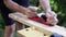 Carving wood plank using hand plane, pov close up