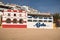 Carvoeiro, Portugal - 10 December, 2016: colorful traditional portuguese architecture houses on sandy beach in blue sky