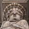 Caryatid stained sculpture adorns the old house facade on the street of Budapest