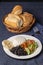 Casado, typical Costa Rican dish with rice, beans and vegetables on a table with blue tablecloth