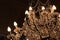 Cascade of crystals in antique chandelier, darkened room