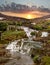 The cascade of falls on a sunset in mountains