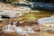 Cascade of rapids on a quiet mountain river in a shady canyon