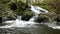 Cascade on small mountain stream, water is running