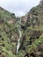 Cascade on the volcanic cliff of Paul do Mar in Madeira