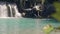 Cascade waterfall splashing in tropical waterfall and young woman swimming in fresh water. Beautiful tropical waterfall