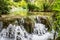 Cascades waterfalls, among the green grass. Plitvice, National Park, Croatia