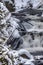 Cascades and waterfalls surrounded by pine trees and snow in Yellowstone