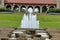 A cascading fountain with towers of water overlooking a pavilion