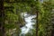 Cascading water close to the McDonald Lake in the Glacier National Park, Montana