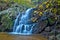 Cascading woodland waterfall and fall foliage