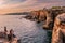 Cascais, Portugal - 29 September 2020 - Tourists sitting by the sea near the famous Boca do Inferno at sunset