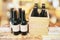 Case of beer and black bottles on wooden table