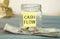 Cash flow text on a glass jar with