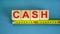 `Cash` word on cubes arranged behind the ruler on beautiful blue background. Concept