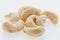 Cashew nuts heap peeled on a white background