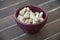 Cashew nuts inside bowl on wood close up