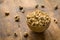 Cashews in ceramic bowl on textured wooden background