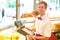 Cashier in baker\'s shop posing with cash register