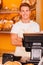 Cashier in bakery shop.