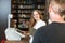 Cashier in bookstore serving a customer or client