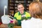 Cashier in flower shop serving client