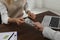 Cashier giving money to businessman at desk in bank