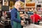 Cashier with green apron at the cash register