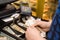 Cashier holds banknotes and uses cash register