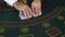 Casino, blackjack, dealer hands shuffle a deck of playing cards