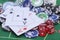 Casino chips, cards and dices on green felt game table