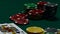 Casino chips and poker cards on green table