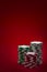 Casino and gambling concept with three stacks of chips of different colors red, green and white/ grey isolated on a red felt