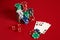 Casino gambling poker equipment and entertainment concept - close up of playing cards and chips at red background. Three