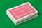 Casino playing cards on green table