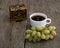 Casket, coffee and cluster of grapes