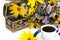 Casket, cup of coffee, bouquet of wild flowers and yellow flower