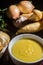 Cassava broth in a white bowl, ingredients on the side, copy space and dark background