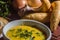 Cassava broth in a white bowl, ingredients on the side, copy space and dark background