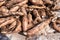 Cassava for tapioca flour industry, raw yucca tuber, pile of cassava