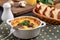 Casserole with chicken, mushrooms and cheese, known in Russia as julienne in white bowl with herbs on a kitchen towel