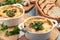 Casserole with chicken, mushrooms and cheese, known in Russia as julienne in white bowls with herbs