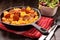 Casserole with chorizo sausage in a frying pan