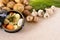 Casserole dish with organic winter vegetables and herbs on kitchen worktop, copy space