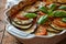 a casserole dish with vegetables and basil