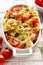 Casserole with farfalle pasta, cherry tomato, mozzarella cheese and thyme