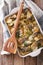 Casserole of potatoes, herring in cream sauce in baking dish. ve