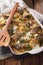 Casserole of potatoes, herring fish in a creamy sauce close up i