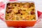 Casserole with potatoes, sausages, tomatoes and cheese.