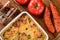 Casserole with potatoes, sausages, tomatoes and cheese.